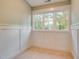 This bedroom has painted wainscoting, carpet flooring, and large windows that provide great lighting at 608 Hemlock Ave, Durham, NC 27707