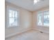 Bright, neutral bedroom featuring two windows, carpeted floors, and ample natural light at 608 Hemlock Ave, Durham, NC 27707