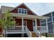 Charming red craftsman-style home with white trim and a welcoming front porch with an inviting entrance at 608 Hemlock Ave, Durham, NC 27707