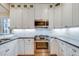 Bright kitchen featuring white cabinets, stainless steel appliances, and elegant countertops at 608 Hemlock Ave, Durham, NC 27707
