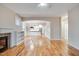 Spacious living room featuring hardwood floors, fireplace, and an open layout leading to the kitchen at 608 Hemlock Ave, Durham, NC 27707