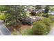 An aerial view showing the home's layout, with a large lot and mature trees at 609 W Main St, Benson, NC 27504