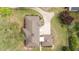 Aerial view of the stone house showcasing the roof, landscaping, and driveway at 609 W Main St, Benson, NC 27504