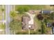 An aerial perspective shows the stone home, highlighting its landscaping and driveway layout at 609 W Main St, Benson, NC 27504
