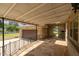Covered patio with view of the detached garage, stone facade and landscaped backyard at 609 W Main St, Benson, NC 27504