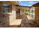 Back patio featuring stone flooring, exterior stone and view to landscaped yard at 609 W Main St, Benson, NC 27504