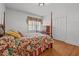 Cozy bedroom features a four-poster bed with a floral comforter and wood floors at 609 W Main St, Benson, NC 27504