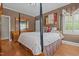 Bedroom with four-poster bed, hardwood floors, and a classic, elegant style at 609 W Main St, Benson, NC 27504