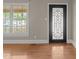 Entryway featuring hardwood floors, a decorative front door and window at 609 W Main St, Benson, NC 27504