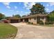 Lovely home exterior with a detached garage, circular driveway, and well-kept lawn at 609 W Main St, Benson, NC 27504