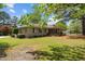 Beautiful stone home featuring a well-manicured lawn with decorative shrubbery at 609 W Main St, Benson, NC 27504