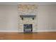 Close up of the living room stone fireplace with a dark mantle at 609 W Main St, Benson, NC 27504