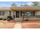 Charming home featuring a stone facade, covered porch, and manicured landscaping at 609 W Main St, Benson, NC 27504
