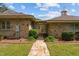 Beautiful home exterior showcasing stone architecture, a stone pathway, and landscaped bushes at 609 W Main St, Benson, NC 27504