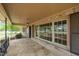 Inviting covered porch featuring stone flooring, stone columns, and large windows at 609 W Main St, Benson, NC 27504