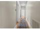 Long hallway featuring hardwood floors, neutral walls, and classic trim at 609 W Main St, Benson, NC 27504