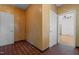 Hallway with doors and tile flooring leading to other rooms in the house at 609 W Main St, Benson, NC 27504