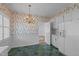 Charming kitchen features white cabinets and a bright chandelier over the dining area at 609 W Main St, Benson, NC 27504