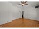 Bright living room featuring wood floors, neutral walls, and a ceiling fan at 609 W Main St, Benson, NC 27504