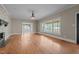 Open living area featuring hardwood floors, large windows, and a stone fireplace at 609 W Main St, Benson, NC 27504