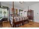 Charming main bedroom featuring a four-poster bed, hardwood floors, and elegant decor at 609 W Main St, Benson, NC 27504