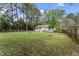 Large grassy backyard with mature trees, offering ample space for recreation and enjoying nature at 711 Horton Rd, Durham, NC 27704