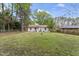 Spacious backyard with a green lawn and mature trees, perfect for outdoor activities and relaxation at 711 Horton Rd, Durham, NC 27704