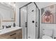 Modern bathroom featuring a glass-enclosed shower, wooden vanity, and contemporary fixtures at 711 Horton Rd, Durham, NC 27704