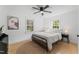 Cozy bedroom with a queen-sized bed, hardwood floors, and ample natural light from large windows at 711 Horton Rd, Durham, NC 27704