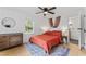 Inviting bedroom with hardwood floors, a comfortable bed, and natural light from a large window at 711 Horton Rd, Durham, NC 27704