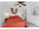 Cozy bedroom featuring a ceiling fan, minimalist decor, and a comfortable-looking bed with stylish linens at 711 Horton Rd, Durham, NC 27704