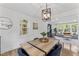 Dining room featuring a wooden table, blue upholstered chairs, and an open view to the living room at 711 Horton Rd, Durham, NC 27704