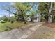 Charming home with mature trees and a well-kept lawn, creating an inviting curb appeal at 711 Horton Rd, Durham, NC 27704