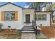 Stunning white brick home with an inviting black front door, and manicured landscaping at 711 Horton Rd, Durham, NC 27704