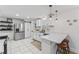 Modern kitchen with white countertops, stainless steel refrigerator, and pendant lighting over the island at 711 Horton Rd, Durham, NC 27704