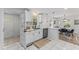 Bright, airy kitchen with white cabinetry, stainless steel appliances, and view to the dining area at 711 Horton Rd, Durham, NC 27704
