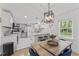 Bright kitchen with stainless steel appliances, white cabinetry, and open layout with dining area at 711 Horton Rd, Durham, NC 27704