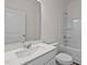 Bathroom with white sink, quartz countertop, chrome fixtures, bathtub, and framed mirror at 7385 Pilatus Ave, Spring Hope, NC 27882