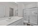 Bright bathroom with modern sink, quartz countertop, framed mirror, and glass shower stall at 7385 Pilatus Ave, Spring Hope, NC 27882