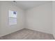 Neutral bedroom with beige carpet, white walls, and window at 7385 Pilatus Ave, Spring Hope, NC 27882