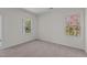 Bright bedroom featuring neutral walls, carpet, and two windows with views at 7385 Pilatus Ave, Spring Hope, NC 27882