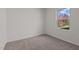 Neutral bedroom with beige carpet and window looking out on trees at 7385 Pilatus Ave, Spring Hope, NC 27882