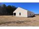 Rear exterior view of this single story home with vinyl siding and a large backyard at 7385 Pilatus Ave, Spring Hope, NC 27882