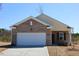 Charming single Gathering home featuring brick and siding facade and an attached two car garage at 7385 Pilatus Ave, Spring Hope, NC 27882