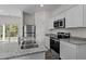 Modern kitchen featuring granite countertops, stainless steel appliances, and white cabinetry at 7385 Pilatus Ave, Spring Hope, NC 27882