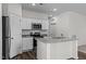 Well-lit kitchen features granite countertops, stainless steel appliances, and ample storage at 7385 Pilatus Ave, Spring Hope, NC 27882