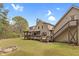 Spacious backyard featuring a wooden deck, pergola, and exterior staircase at 93 Clifton Pond Rd, Louisburg, NC 27549