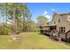 Expansive backyard includes a deck, firepit, and outdoor seating for relaxation and entertainment at 93 Clifton Pond Rd, Louisburg, NC 27549