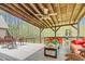 Spacious outdoor deck with furniture, plants, and a view of the surrounding trees at 93 Clifton Pond Rd, Louisburg, NC 27549