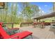 Relax on the expansive wooden deck with lounge chairs, an outdoor dining area, and wooded views at 93 Clifton Pond Rd, Louisburg, NC 27549